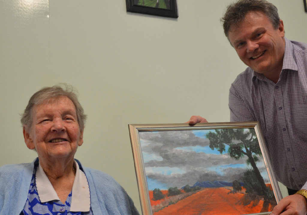 TRIBUTE: Peggy Guy hands her painting to her daughter’s former boss, Paul Barlow, of accountancy firm Barlow Dolling.